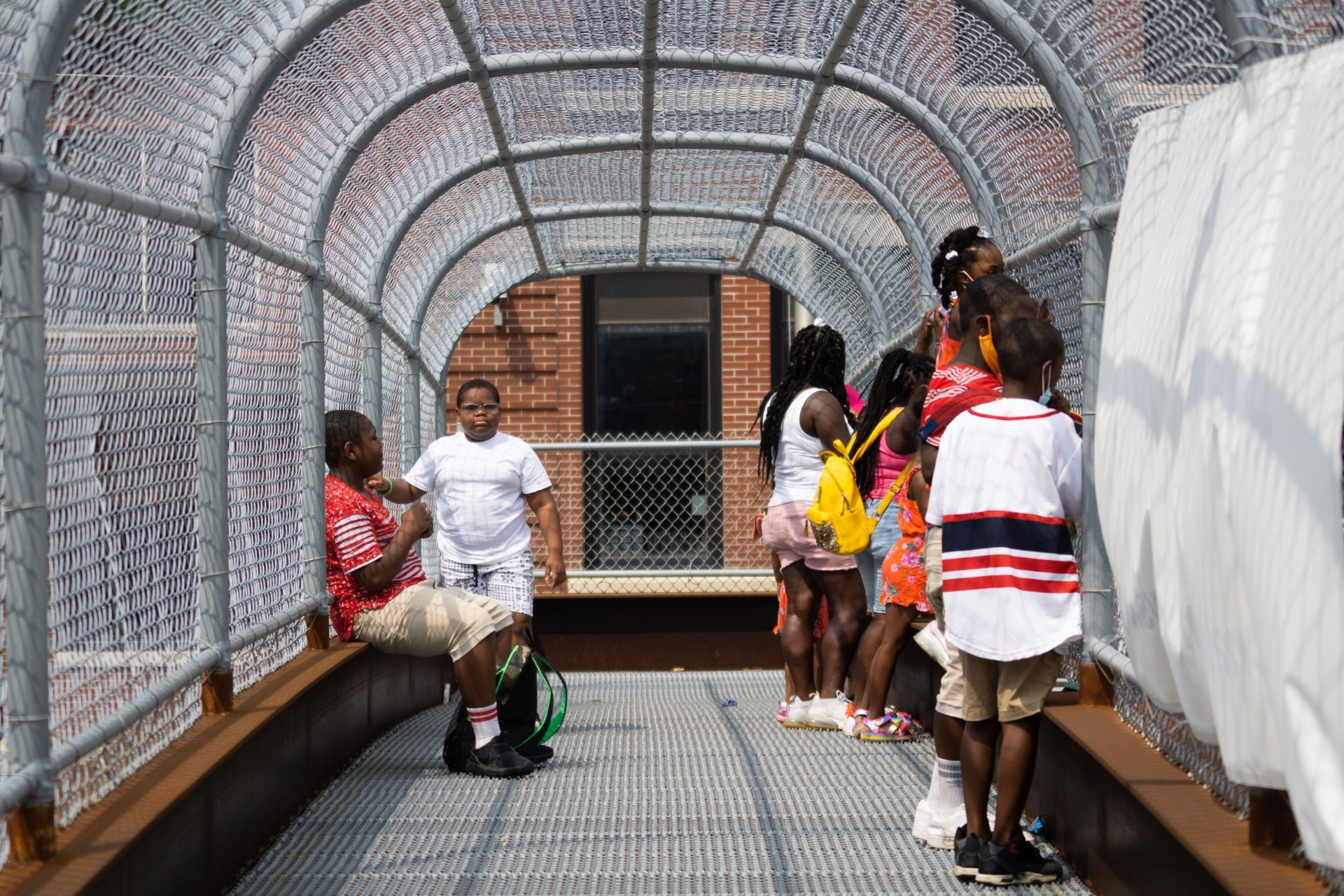 Young kids gathered in a covered walkway