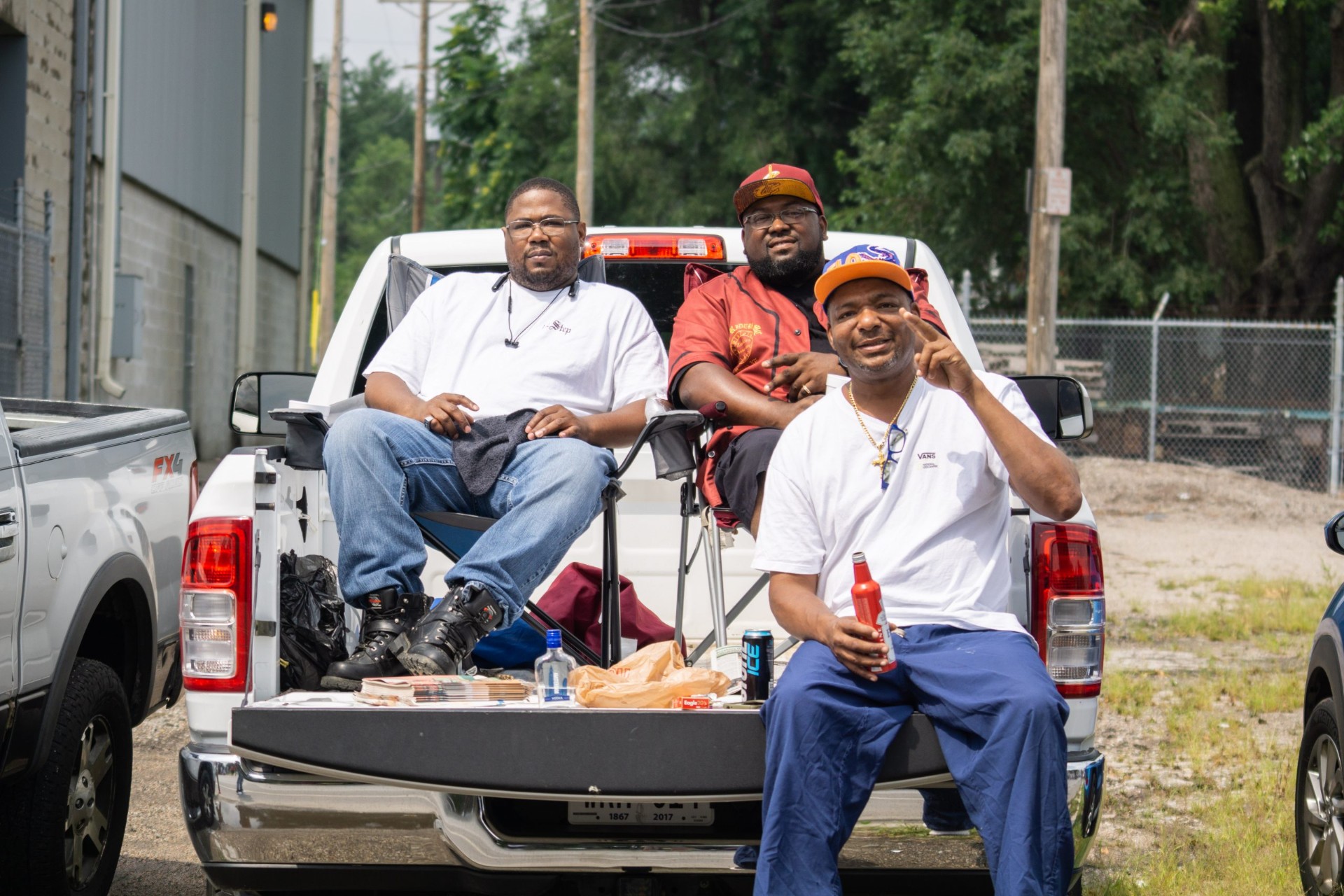 Three friends relaxing in the bed of a pickup truck