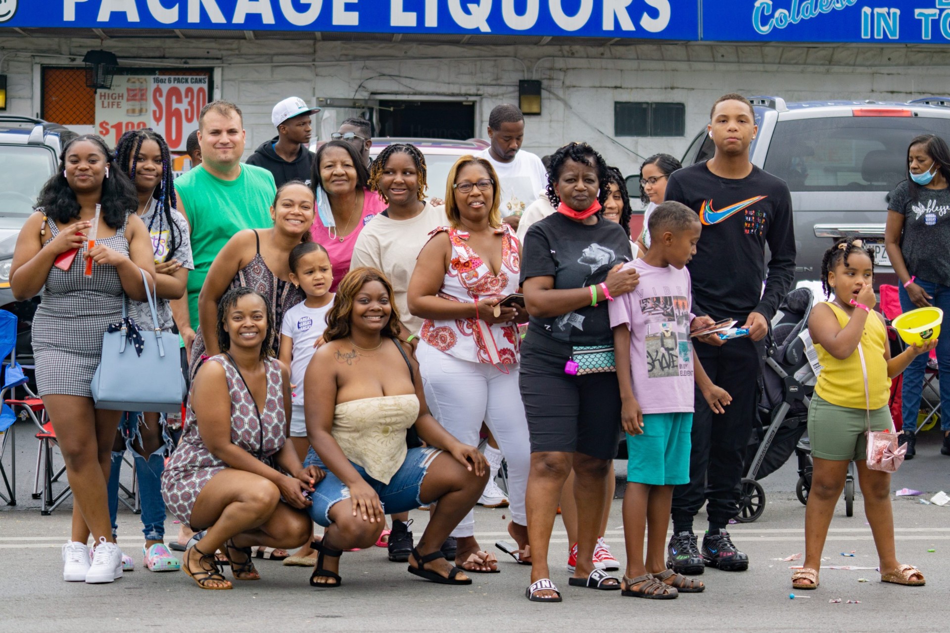 A large family group posing together on the parade route